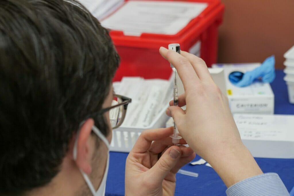 person holding a vaccine