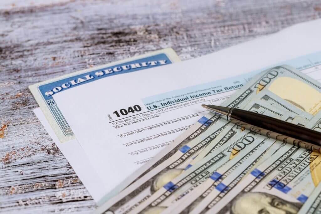 Formulario impositivo, dinero y tarjeta de seguro social para presentar declaración en la temporada de impuestos 2023.