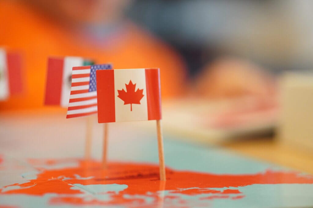Banderas de Estados Unidos y Canadá pinchadas sobre un mapa