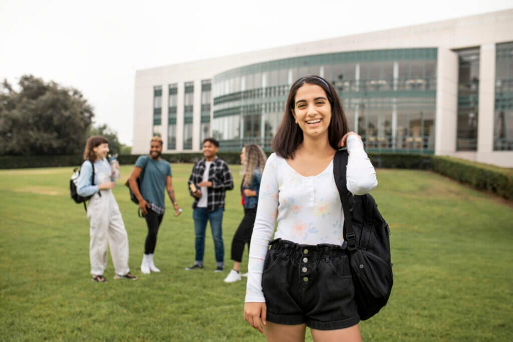 Estudiante de intercambio feliz en el campus luego de hacer el cambio de estatus de visa j1 a f1