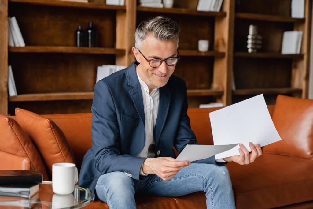 Hombre de negocios escribiendo y analizando una carta de recomendación para un empleado