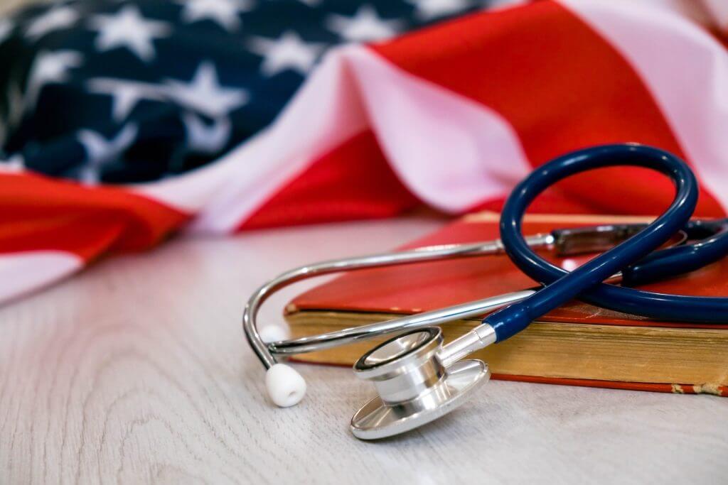 Imagen de un parte médico con la bandera de USA representando que es el obama care y quienes califican