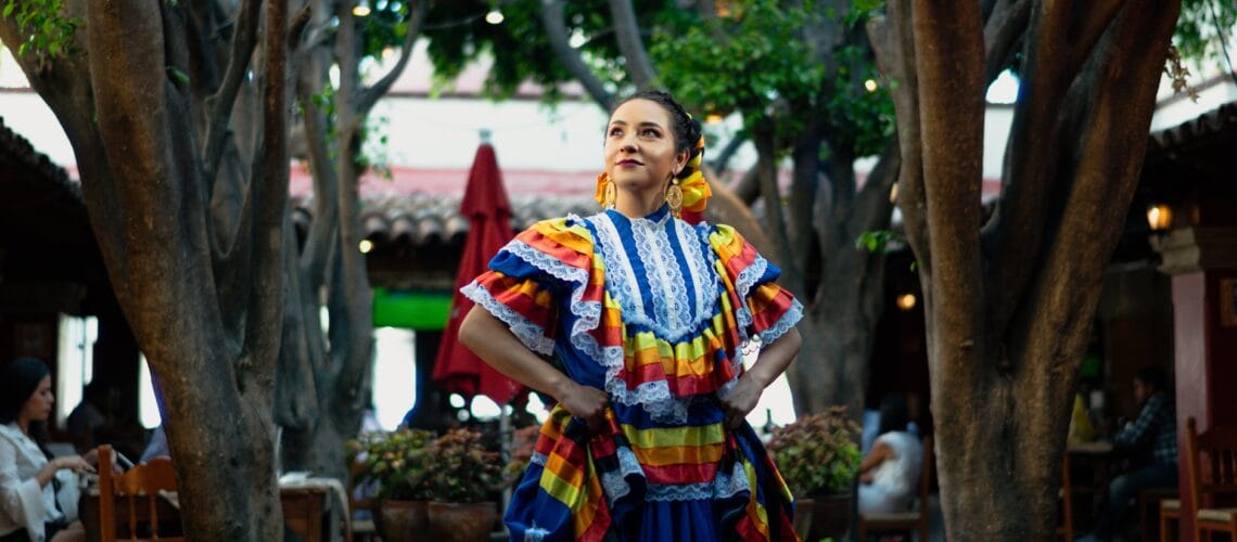 La nota es sobre 4 feriados en Estados Unidos que tienen historias vinculadas con migrantes. La imagen es de una bailarina mexicana por el Cinco de Mayo.
