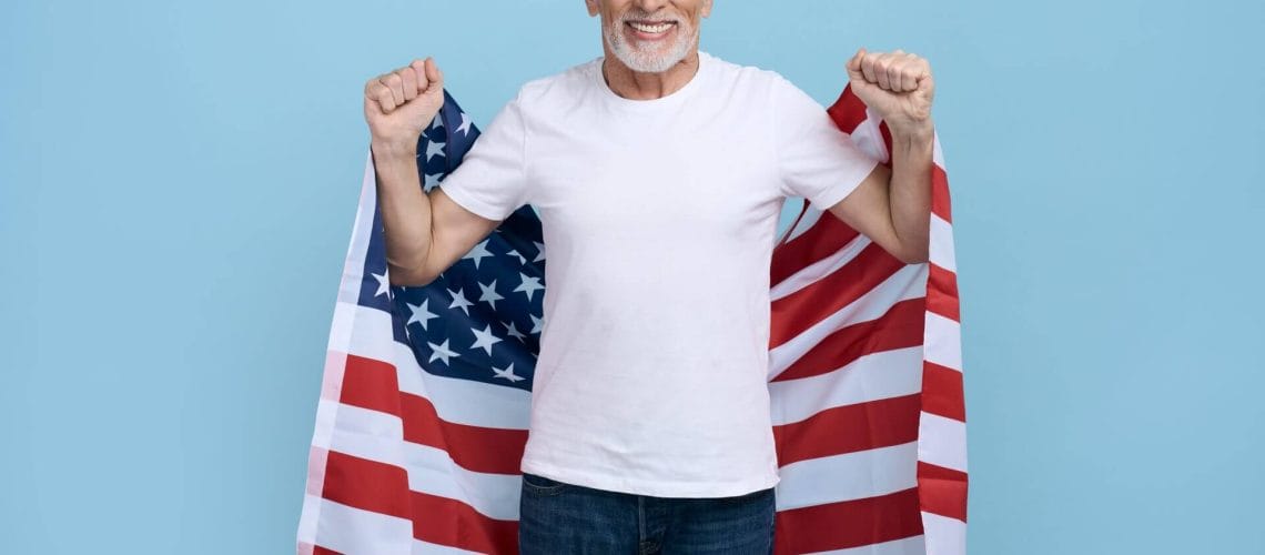 Hombre mayor con bandera de USA celebrando permiso de trabajo para refugiados